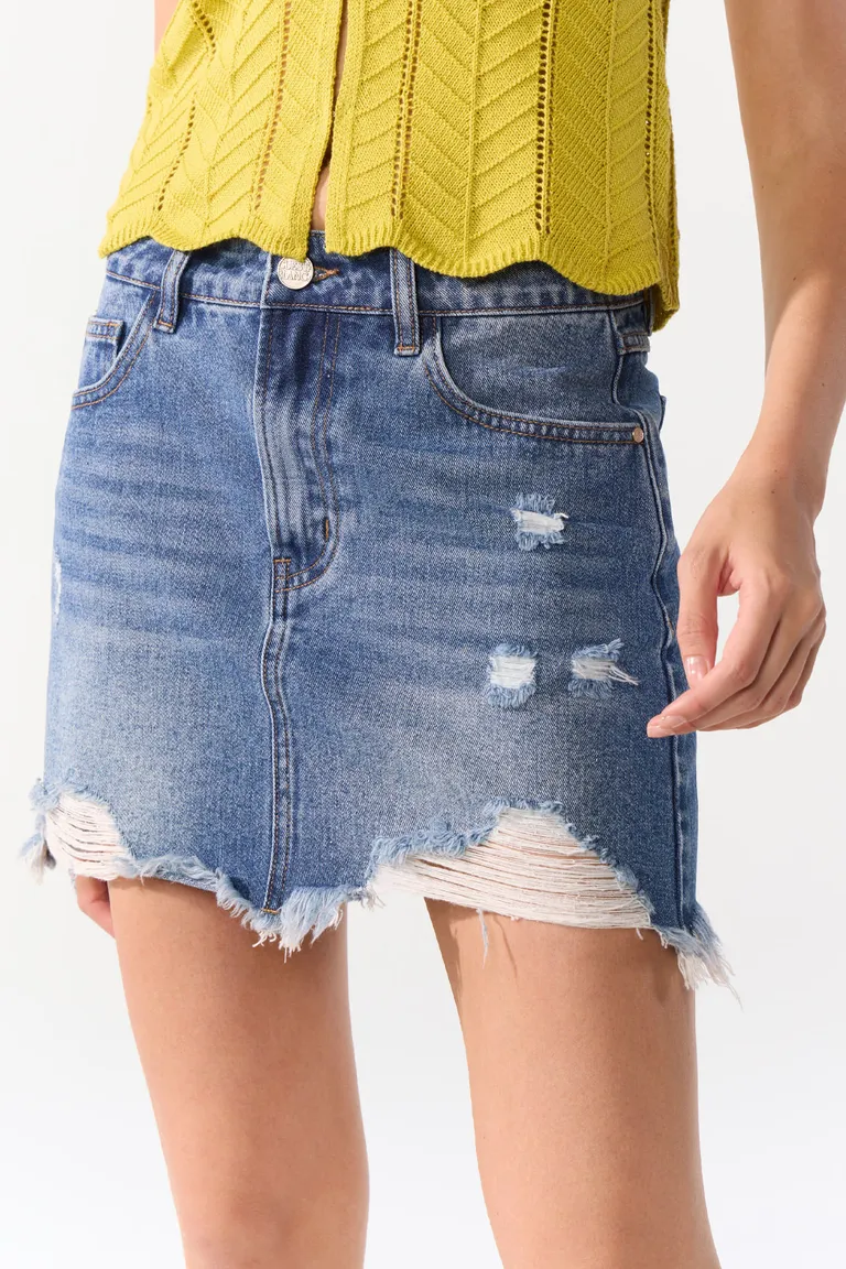 Mini falda de jean cinco bolsillos con roturas y ruedo irregular de Cuesta Blanca en Faldas para argentina