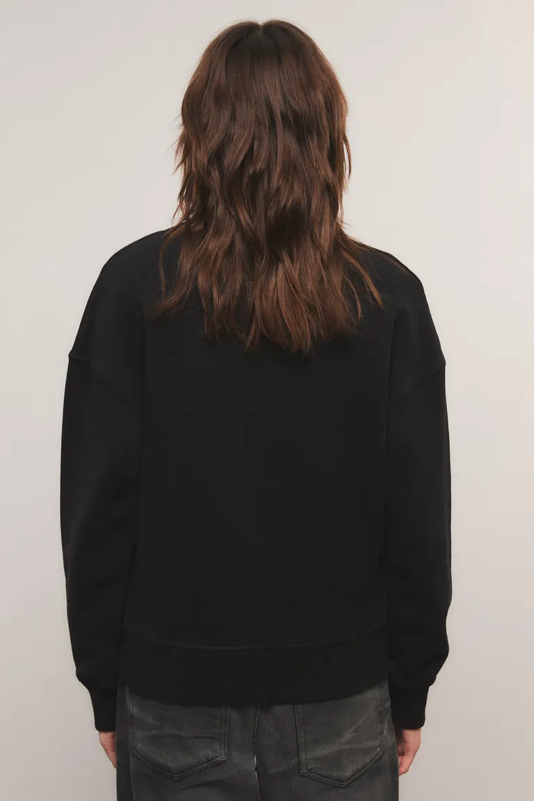 Buzo con cuello redondo, mangas largas y detalle de bordado en el frente de Kosiuko en Buzos y Sweaters para argentina