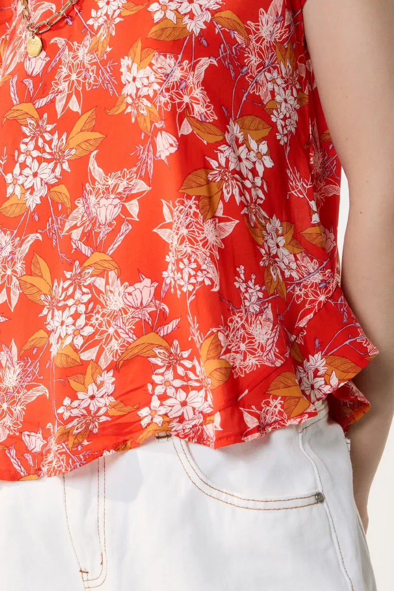 Blusa de mujer con estampado de flores rojo con escote en V y diseño asimétrico de Cuesta Blanca en Blusas para argentina