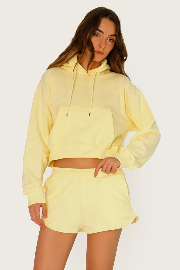 Buzo corto de algodón amarillo con bordados y cordón ajustable en el cuello de Sofia Sarkany en Buzos y Sweaters para argentina