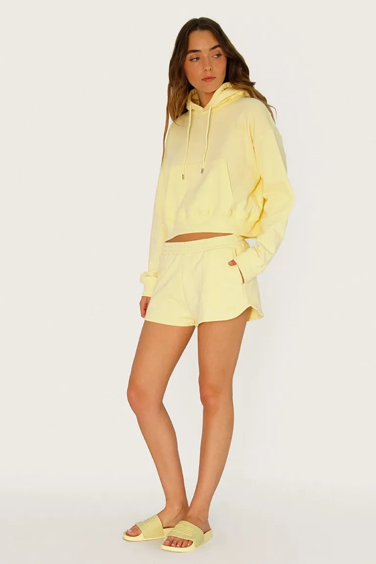 Buzo corto de algodón amarillo con bordados y cordón ajustable en el cuello de Sofia Sarkany en Buzos y Sweaters para argentina