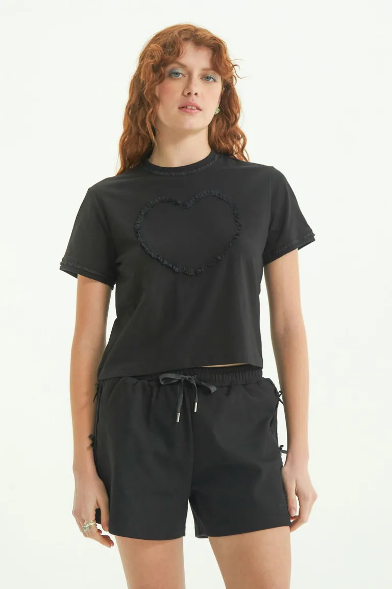 Remera negra con aplicación de encaje y detalles románticos de Las Pepas en Remeras para argentina