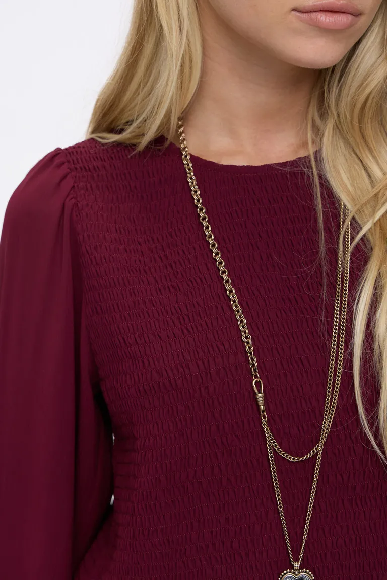 Blusa entallada con fruncido en el torso, volados en el ruedo y mangas largas con puños elastizados de Cuesta Blanca en Blusas para argentina