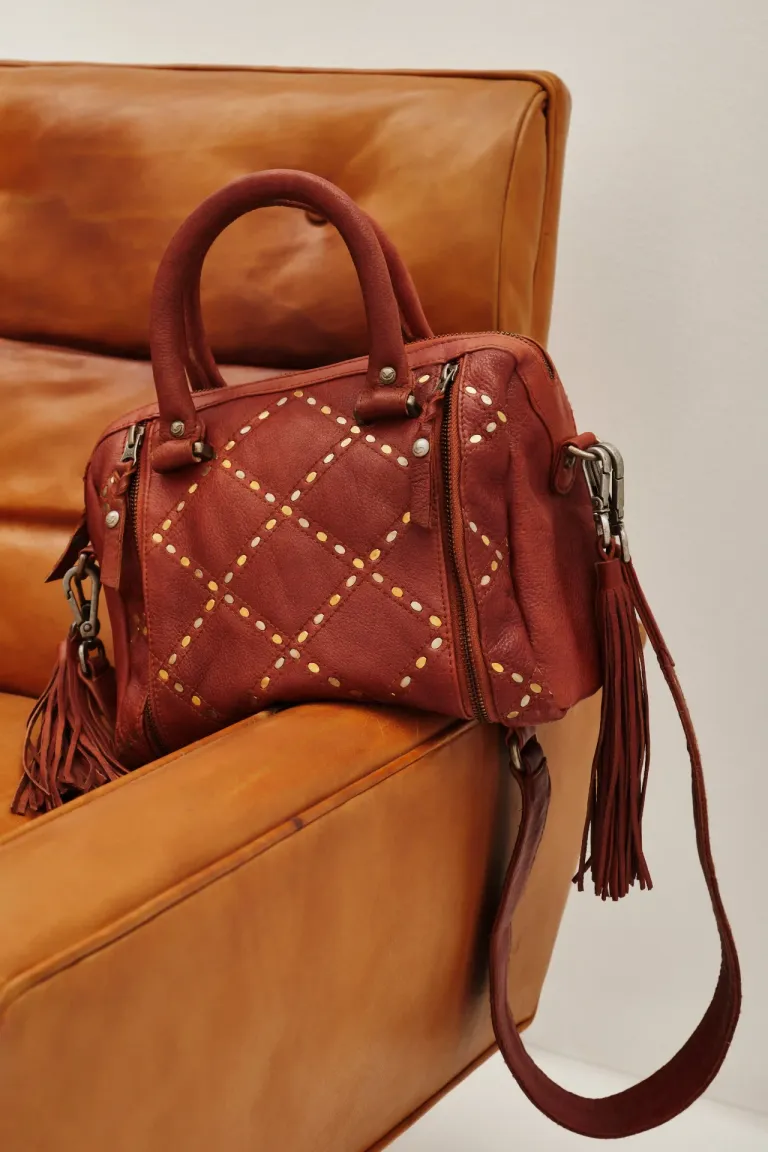 Cartera de mano estructurada con tachas decorativas, frente matelaseado, correa larga desmontable y apliques de flecos laterales de Rapsodia en Bolsos y Carteras para argentina