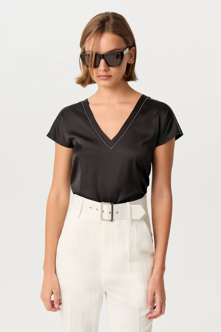 Remera negra de escote en V con acabado metálico, de corte relajado y estilo atemporal de Markova en Remeras para argentina