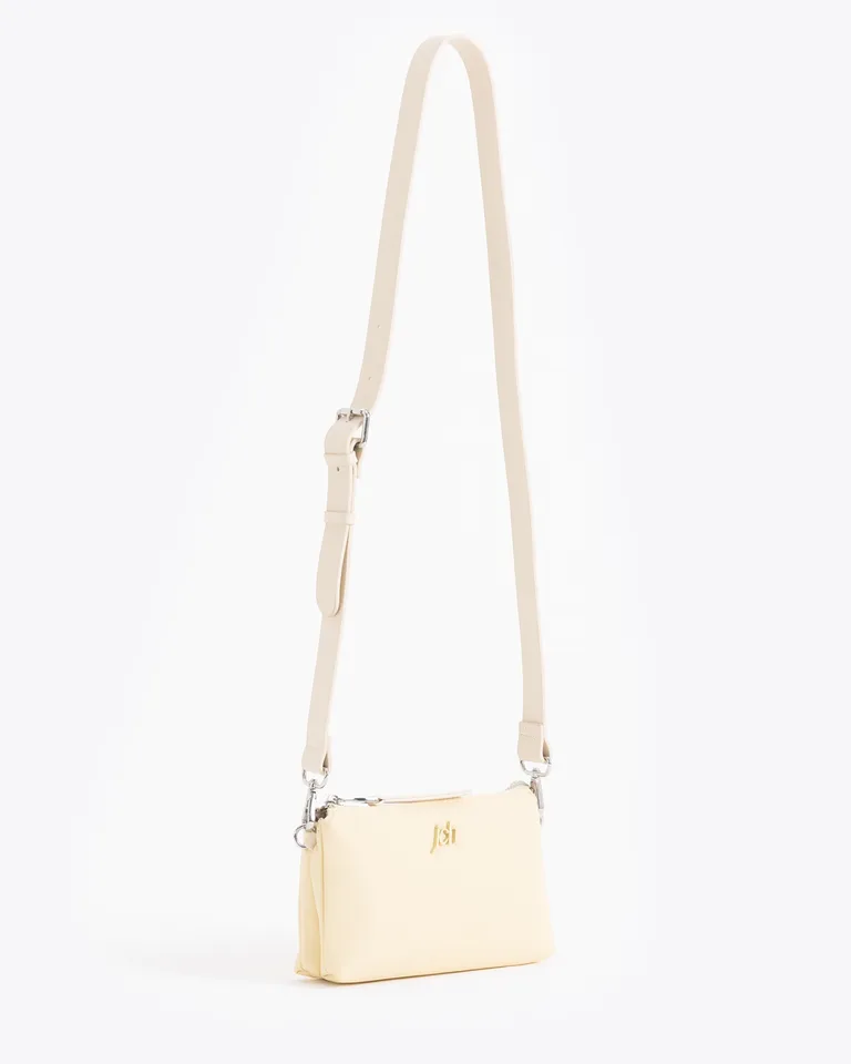 Mini cartera rectangular compacta con correa ajustable y cierre superior con aplique metálico frontal de Jazmin Chebar en Bolsos y Carteras para argentina