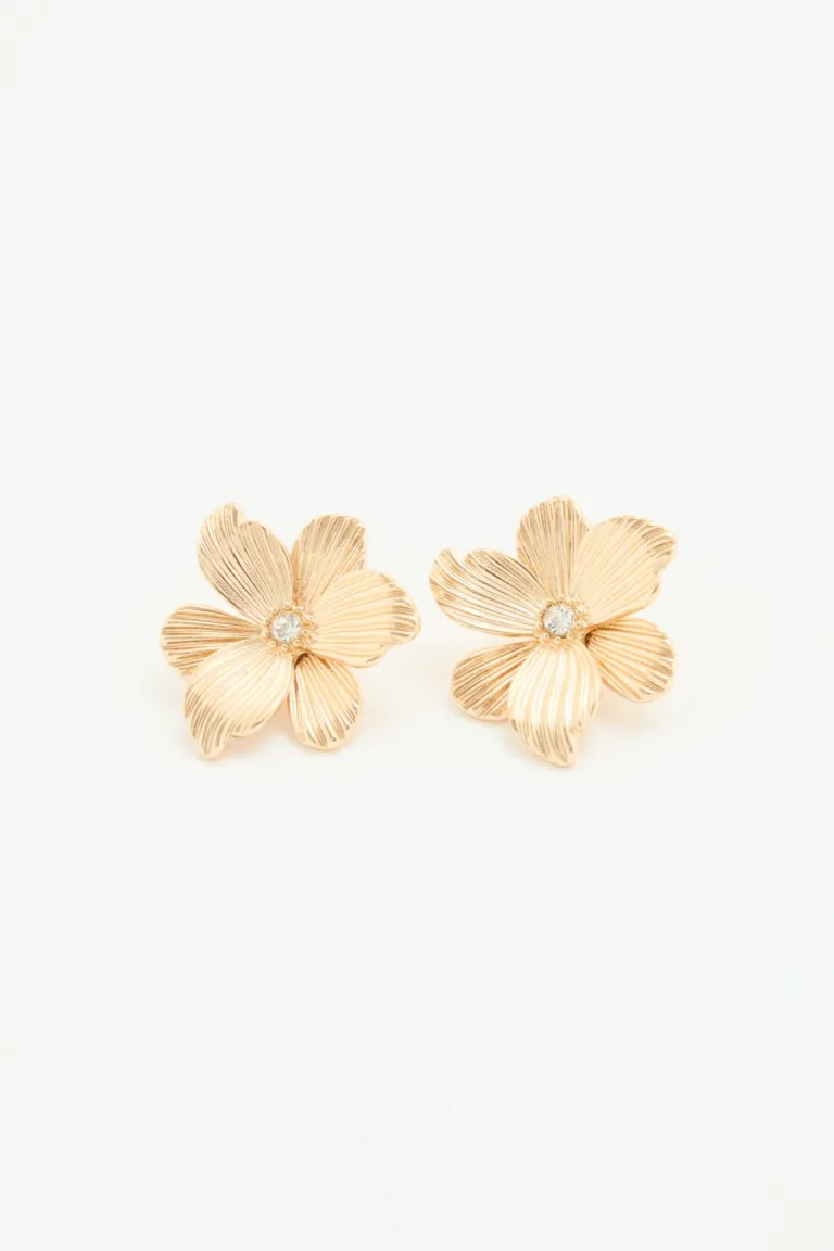 Aros pasantes con forma de flor y centro de strass, color dorado de Rapsodia en Bijouterie para argentina