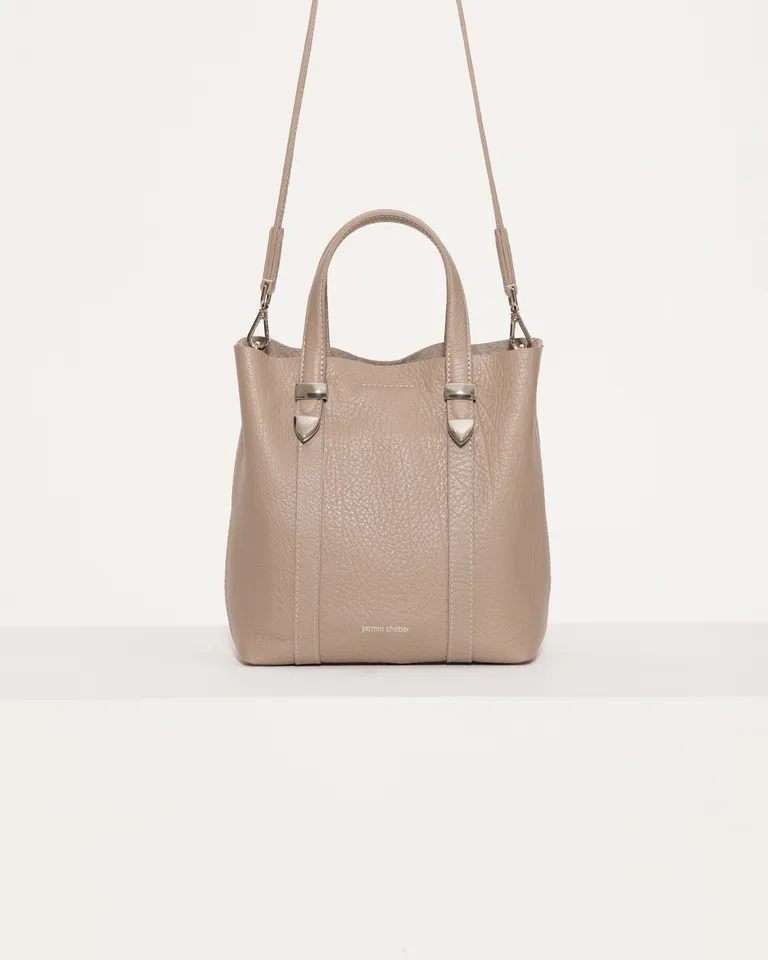 Cartera de mano de cuero gris con detalles metálicos y cierre magnético de Jazmin Chebar en Bolsos y Carteras para argentina