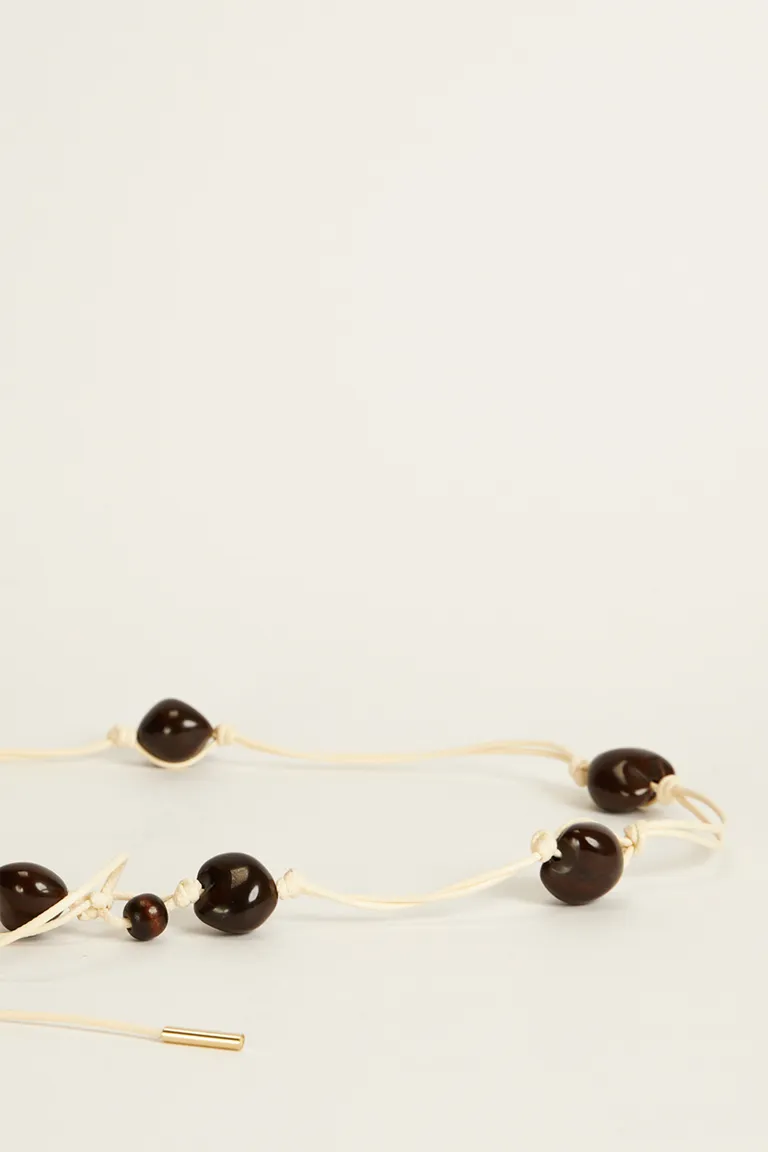 Cinturón artesanal con semillas irregulares - Accesorio de moda para mujer de Tucci en Cinturones para argentina