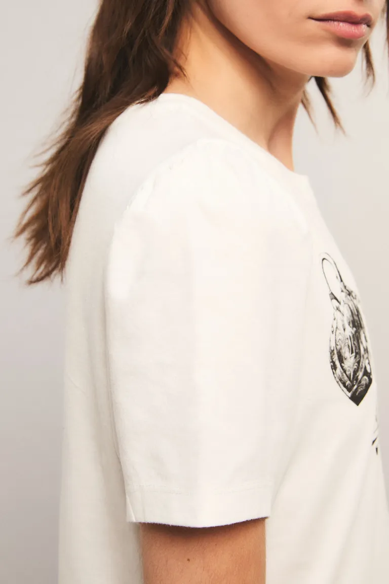 Remera de corte regular con cuello redondo, mangas cortas fruncidas y estampa frontal exclusiva de Kosiuko en Remeras para argentina